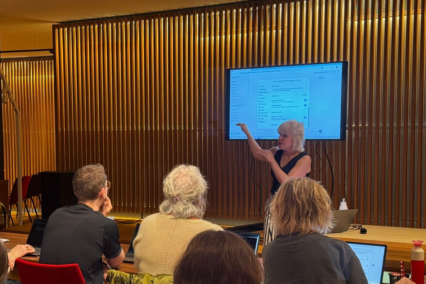 Brooke Gallagher presenting AI setup options on screen to a group of training participants.